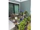 Cozy patio featuring wicker chairs, colorful rug, and assorted plants in a well-decorated outdoor seating area at 5768 75Th N Ter, Pinellas Park, FL 33781