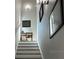 An elegant staircase leading to the upper level, decorated with artwork and soft lighting at 5768 75Th N Ter, Pinellas Park, FL 33781