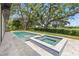 Backyard with a pool, hot tub, patio and green lawn at 634 Poinsettia Rd, Belleair, FL 33756