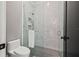 Contemporary bathroom with glass shower, white tile, and sleek fixtures at 634 Poinsettia Rd, Belleair, FL 33756