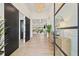 Inviting foyer featuring hardwood floors, a modern chandelier, and views into the expansive living area at 634 Poinsettia Rd, Belleair, FL 33756