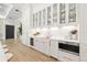 Elegant kitchen with marble countertops, stainless steel appliances, and custom glass-front cabinetry at 634 Poinsettia Rd, Belleair, FL 33756