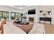 Bright living room features a fireplace, large windows, and comfortable seating for relaxing or entertaining at 634 Poinsettia Rd, Belleair, FL 33756