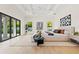 Bright main bedroom with large windows, hardwood floors, and modern décor at 634 Poinsettia Rd, Belleair, FL 33756
