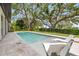Inviting backyard pool area with lounge chairs and beautiful landscaping at 634 Poinsettia Rd, Belleair, FL 33756