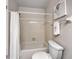 Bright bathroom featuring a shower and tub combo with a white shower curtain and modern toilet at 7508 Hollowell Dr, Tampa, FL 33615