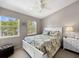 Cozy bedroom with two windows, a ceiling fan, and carpeted floors, creating a comfortable retreat at 7508 Hollowell Dr, Tampa, FL 33615