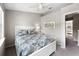 Well-lit bedroom featuring neutral paint, carpet flooring, a ceiling fan, and a doorway leading to another room at 7508 Hollowell Dr, Tampa, FL 33615
