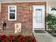 Close up on front door entrance with beautiful red flowers and a floral painting at 7508 Hollowell Dr, Tampa, FL 33615