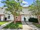 Well-kept townhouse exterior featuring tidy landscaping and inviting front entrances at 7508 Hollowell Dr, Tampa, FL 33615