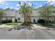Charming townhouse exterior featuring well-maintained landscaping and designated parking at 7508 Hollowell Dr, Tampa, FL 33615
