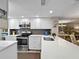 Bright kitchen with stainless steel appliances, white cabinetry, and granite countertops at 7508 Hollowell Dr, Tampa, FL 33615