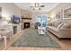 Bright living room with a stone fireplace, a ceiling fan and a sliding door to the patio at 7508 Hollowell Dr, Tampa, FL 33615