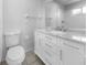 This bathroom features a toilet, modern marble topped vanity with stainless steel hardware, and ample lighting at 804 Pineland Ave, Venice, FL 34285