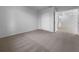 Neutral carpeted bedroom featuring a large closet and an open doorway to the rest of the home at 804 Pineland Ave, Venice, FL 34285