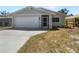 Charming single-story home featuring a two-car garage, screened entry, and freshly landscaped front yard at 804 Pineland Ave, Venice, FL 34285