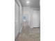 Bright hallway featuring neutral tile flooring and a seamless transition to the living areas of this home at 804 Pineland Ave, Venice, FL 34285