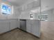 Updated kitchen features white cabinetry, quartz countertops, and stainless steel appliances at 804 Pineland Ave, Venice, FL 34285