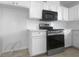 Well-equipped kitchen with stainless steel appliances, white cabinets, and ample counter space at 804 Pineland Ave, Venice, FL 34285