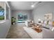 Comfortable living room with tile flooring, neutral paint, stylish furniture and a view of the pool at 804 Pineland Ave, Venice, FL 34285