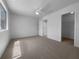 Carpeted main bedroom boasts a ceiling fan, a bright window, and access to the main bathroom at 804 Pineland Ave, Venice, FL 34285