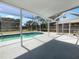 Covered pool area with patio and plenty of room for lounging in the sun at 804 Pineland Ave, Venice, FL 34285