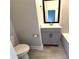 Modern bathroom with gray vanity, quartz countertop, toilet and tub at 813 Burlington N Ave, St Petersburg, FL 33701