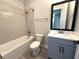 Cozy bathroom features a shower-tub combo, sleek vanity, and a modern design with tiled walls at 813 Burlington N Ave, St Petersburg, FL 33701