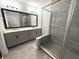 Bathroom featuring double sinks, granite countertops, modern fixtures, and tiled shower at 813 Burlington N Ave, St Petersburg, FL 33701