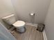Well-kept bathroom features gray floors, toilet and trash can at 813 Burlington N Ave, St Petersburg, FL 33701