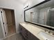Bathroom with a double vanity, granite counters, and a large mirror at 813 Burlington N Ave, St Petersburg, FL 33701