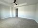 Large bedroom with carpet flooring, neutral paint, and a tray ceiling with fan at 813 Burlington N Ave, St Petersburg, FL 33701