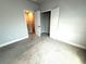 Cozy bedroom with carpeted floor, closet, and a hallway at 813 Burlington N Ave, St Petersburg, FL 33701