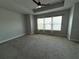 Spacious bedroom with a tray ceiling, carpet flooring, and large windows for plenty of natural light at 813 Burlington N Ave, St Petersburg, FL 33701
