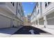 Street view of townhome garages, each with prominent unit numbers, set against a bright, clear sky at 813 Burlington N Ave, St Petersburg, FL 33701