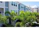 Charming townhome showcasing a lovely facade and complemented by lush, mature palms at 813 Burlington N Ave, St Petersburg, FL 33701