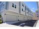Modern townhome community showcasing neat rows of garages and stylish exteriors against a clear blue sky at 813 Burlington N Ave, St Petersburg, FL 33701