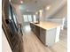 Stylish kitchen island with stainless steel appliances, gray cabinets, and sleek sink fixtures at 813 Burlington N Ave, St Petersburg, FL 33701