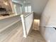 Bright, open-concept living room with a view of the stairs, kitchen, and dining area at 813 Burlington N Ave, St Petersburg, FL 33701