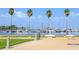 Picturesque waterfront view of a marina filled with sailboats, framed by palm trees against a blue sky at 813 Burlington N Ave, St Petersburg, FL 33701