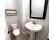 Well-lit powder room featuring a pedestal sink and modern fixtures, complete with a decorative shelf at 813 Burlington N Ave, St Petersburg, FL 33701
