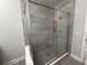 Modern bathroom with a frameless glass shower, tiled walls, and chrome fixtures at 813 Burlington N Ave, St Petersburg, FL 33701