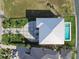 An aerial view reveals the modern home, its well-kept lawn and hardscape, plus a sparkling pool at 90 Martinique Ave, Tampa, FL 33606