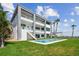 Beautiful home exterior featuring a pool, balconies, and lush green lawn at 90 Martinique Ave, Tampa, FL 33606