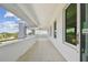 Wide covered balcony with tile flooring offers street views and a ceiling fan at 90 Martinique Ave, Tampa, FL 33606