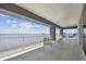 Expansive covered balcony with white railing, offering panoramic water views and comfortable seating at 90 Martinique Ave, Tampa, FL 33606
