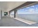 Spacious covered balcony featuring tile floors and serene water views, perfect for outdoor relaxation at 90 Martinique Ave, Tampa, FL 33606