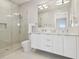 Contemporary bathroom featuring a glass-enclosed shower, double vanity, and marble tile at 90 Martinique Ave, Tampa, FL 33606