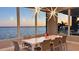 Dining room with scenic water views, a modern light fixture, and dining table for eight at 90 Martinique Ave, Tampa, FL 33606