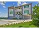 Elegant two-story home with a well-manicured lawn and symmetrical landscaping, showcasing modern architectural design at 90 Martinique Ave, Tampa, FL 33606